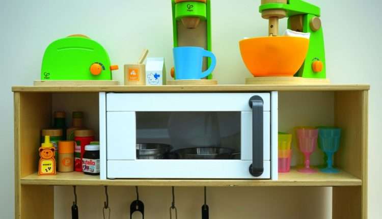 white oven in brown wooden rack