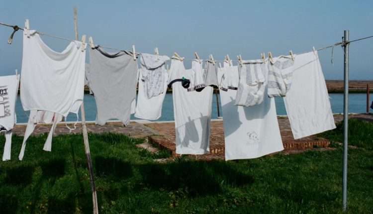 linen hanging on clothesline on grassy seacoast